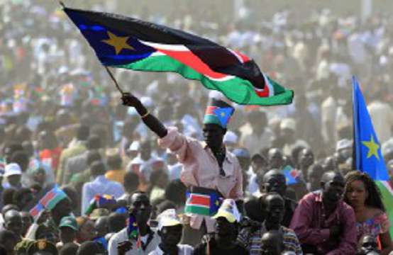 A man waves South Sudan's national flag as he attends the Independence Day celebrations in the capital Juba