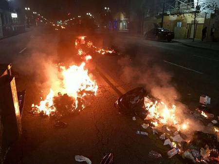 Dumpster fires burn along Broadway in Oakland the early morning hours of Nov. 9, 2016 after demonstrators took to the streets to protest the election of New York businessman Donald Trump as president of the United States.